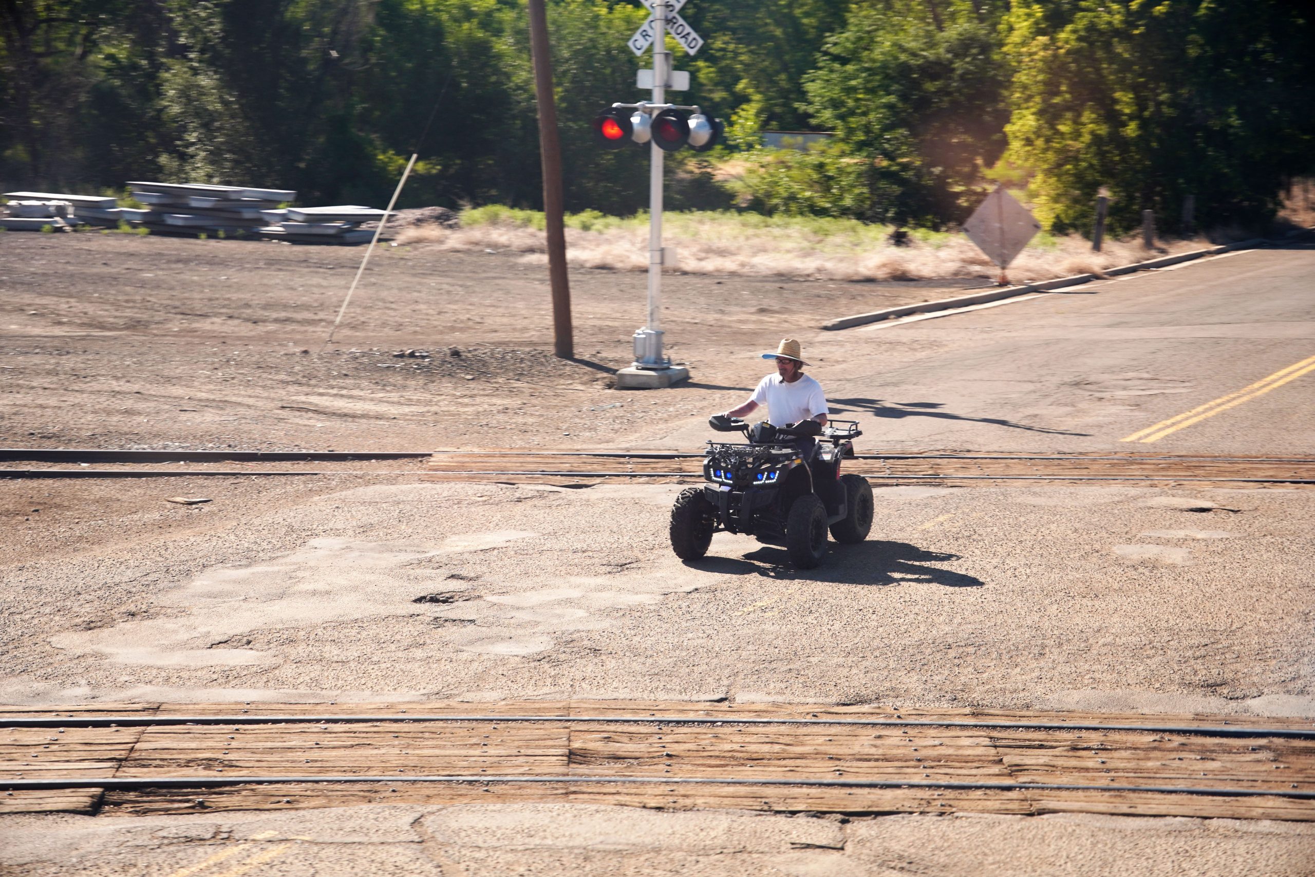 ATV rider waits for train to pass.